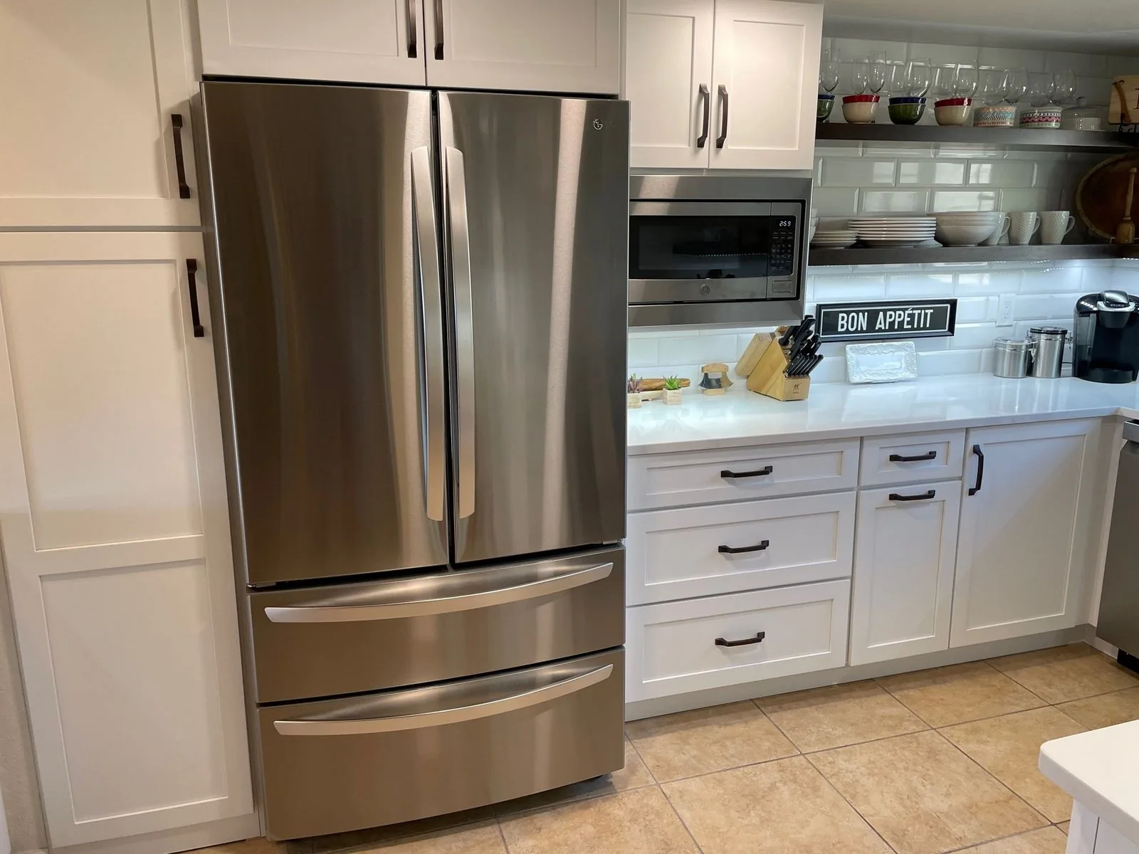 White shaker kitchen cabinetry with quartz counters and open shelving