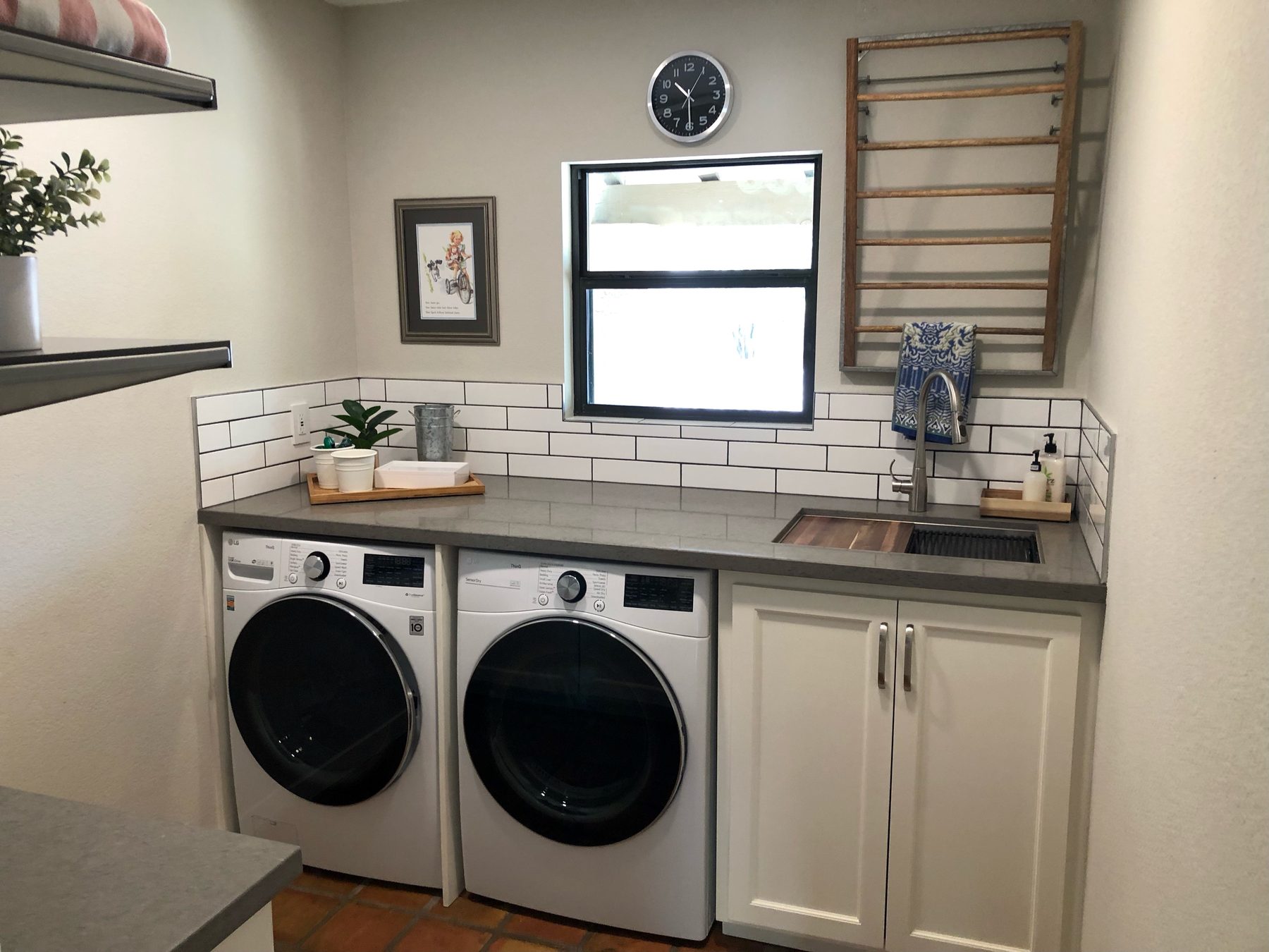 New flooring and cabinetry in a remodeled laundry room