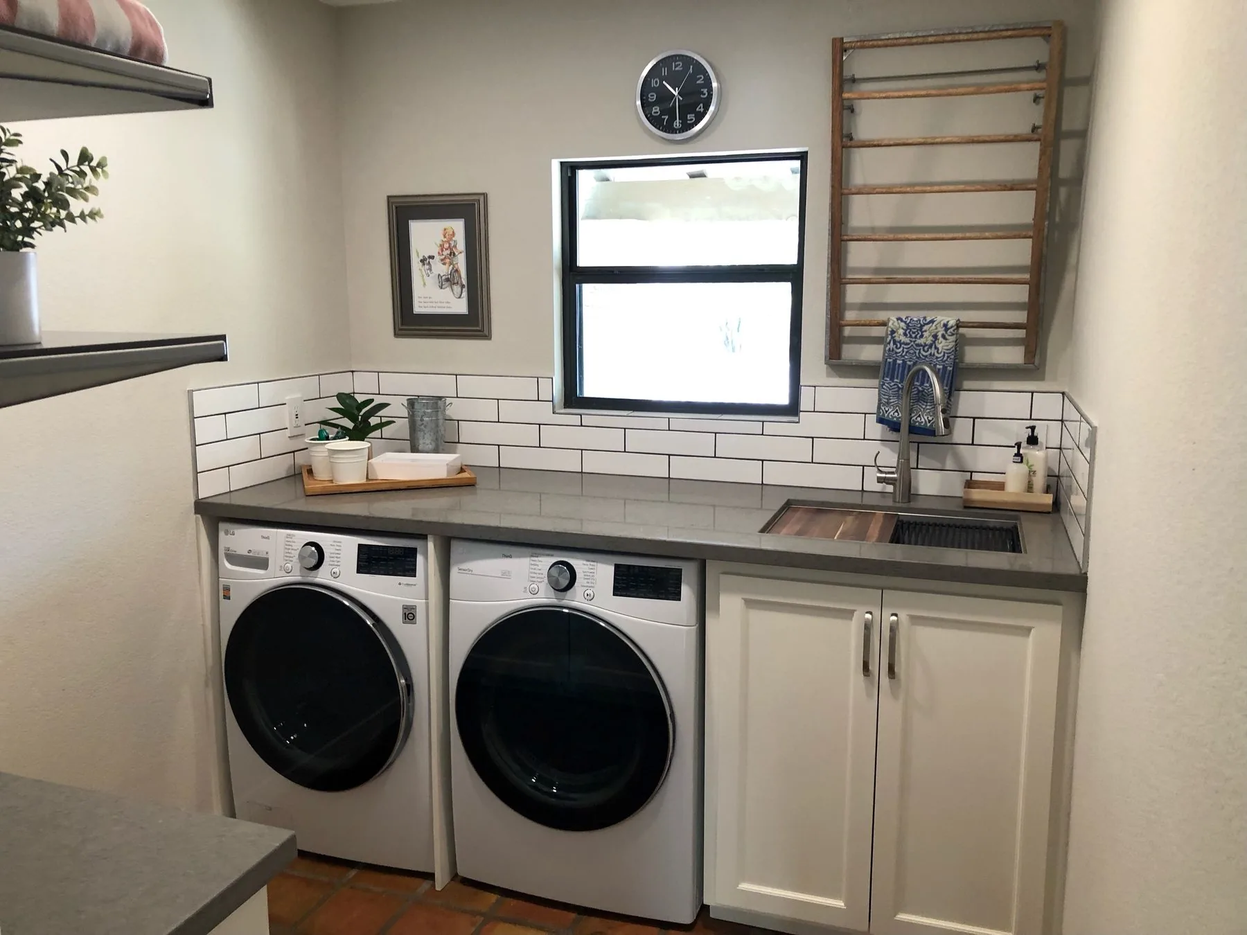 New flooring and cabinetry in a remodeled laundry room